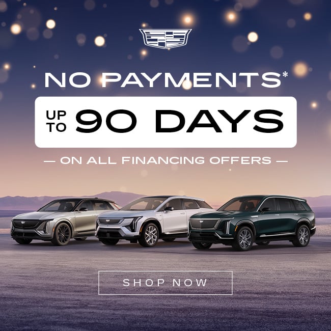 Cadillac SUV lineup with "No Payments Up to 90 Days" financing offer. Twilight sky background.